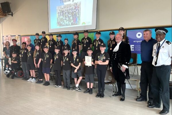 Peasedown St John Mini-Police graduate at a special school assembly with representatives from the local community in attendance.
